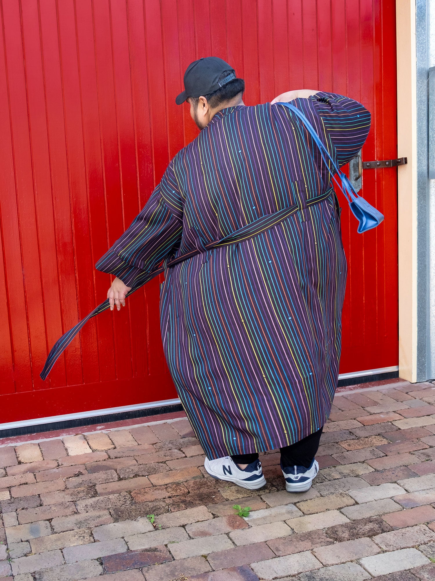 black with rainbow pinstripe printed robe in smooth fabric with adjustable tie belt and large pockets