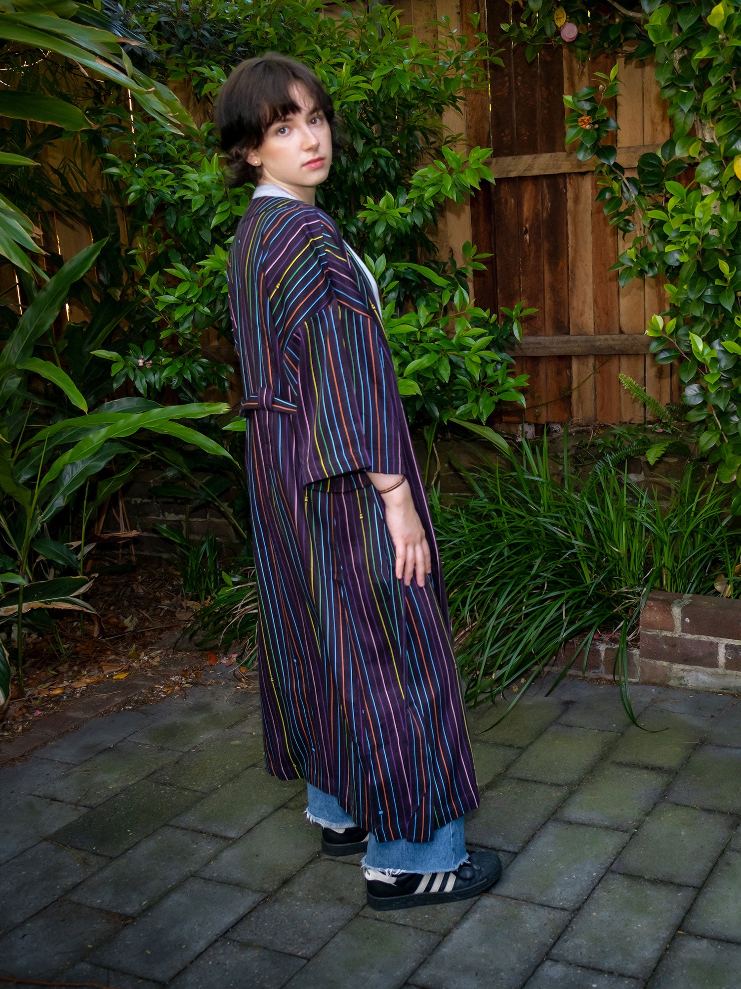 black with rainbow pinstripe printed robe in smooth fabric with adjustable tie belt and large pockets