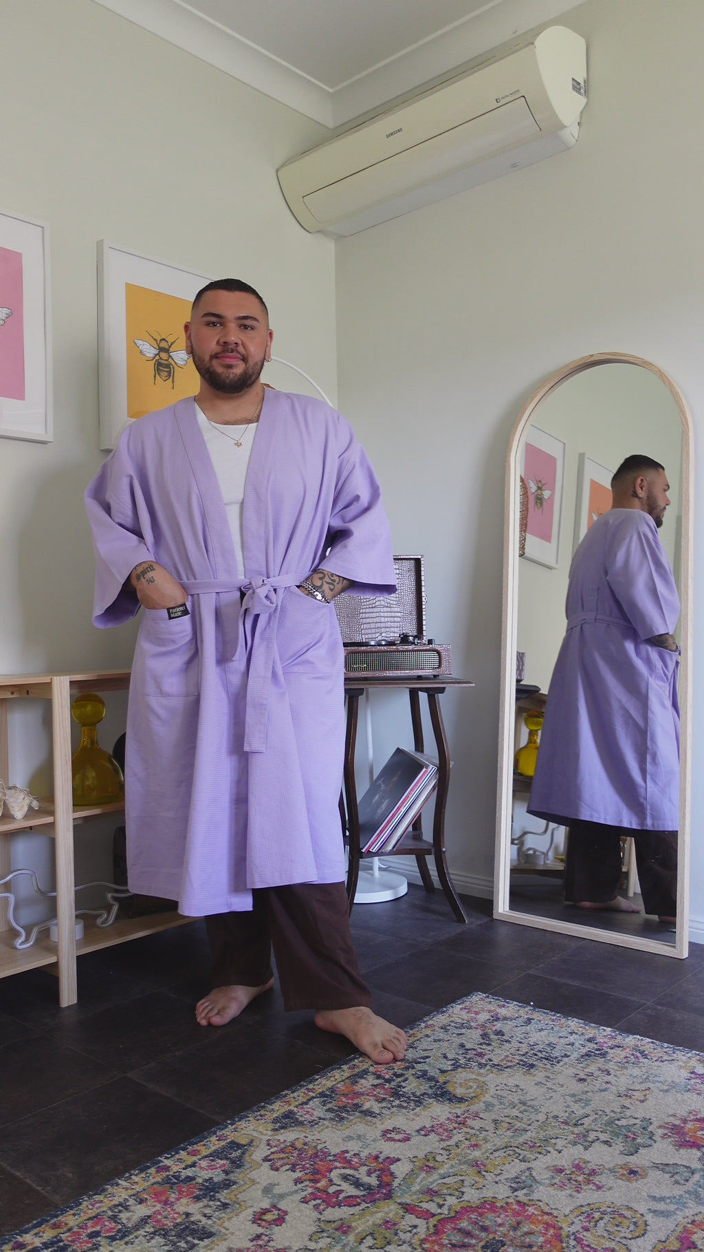 video of man twirling to show details of Lavender mid purple coloured  cotton waffle robe with adjustable tie belt and large pockets